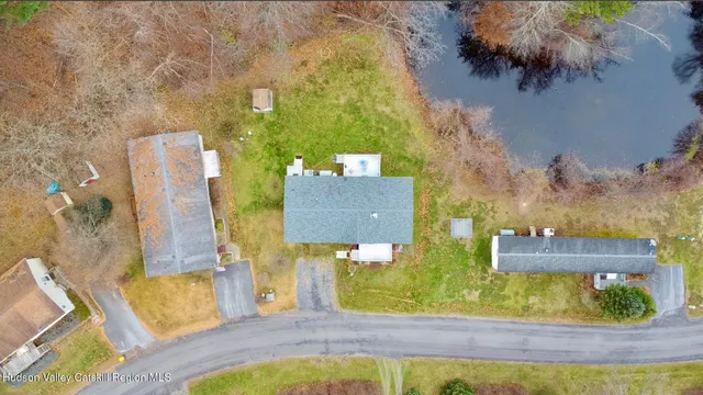 an aerial view of residential house with outdoor space and swimming pool