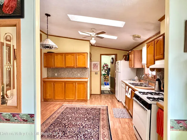 a kitchen with stainless steel appliances granite countertop a refrigerator and a stove