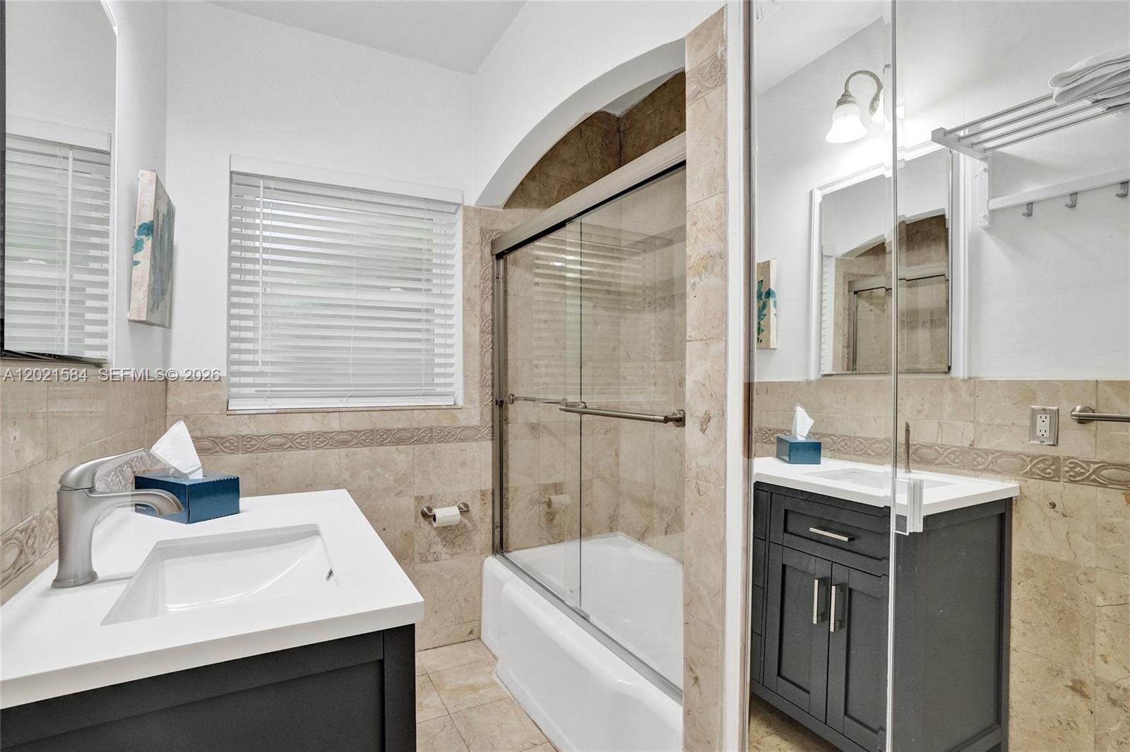 811 Northeast 73rd Street Miami, FL 33138 - Photo 33 of 51 a bathroom with a tub sink and mirror