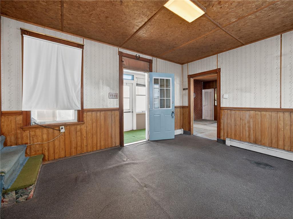 15845 Kutztown Road Mertztown, PA 19539 - Photo 9 of 24 A versatile interior space featuring wood paneling and multiple doorways, ready for your creative touch.