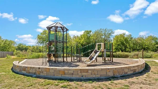 a view of a park with iron fence