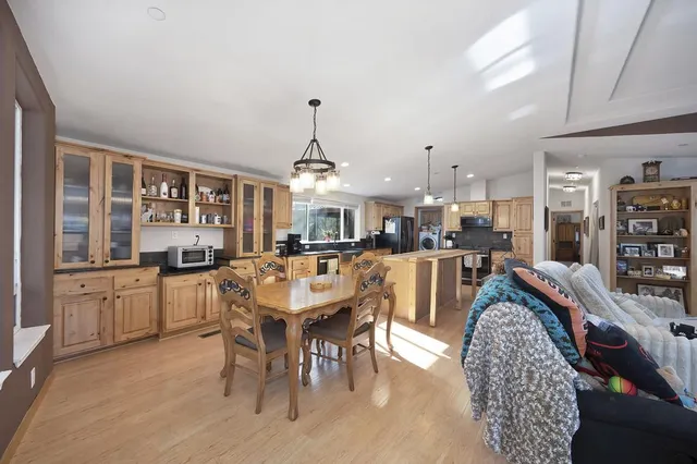 a view of a kitchen with stainless steel appliances granite countertop a refrigerator a oven and a sink with granite countertops