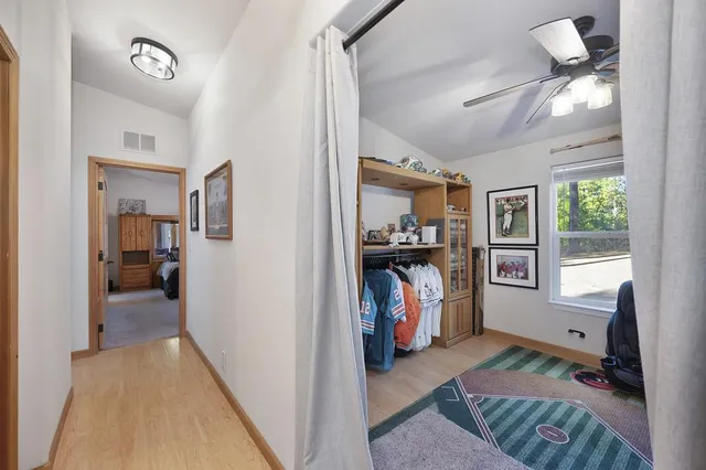 a bedroom with a large bed and a flat screen tv