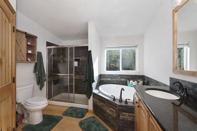 an aerial view of residential house with outdoor space and trees all around