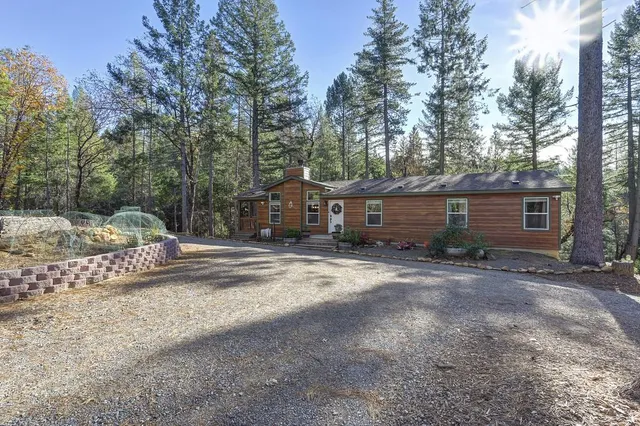 a view of a house with a yard and sitting area