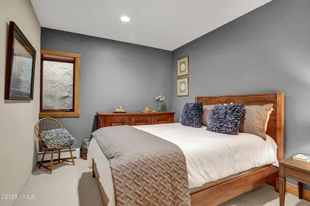 a view of a house with a yard and large trees