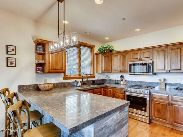 a bathroom with a granite countertop sink a toilet and mirror