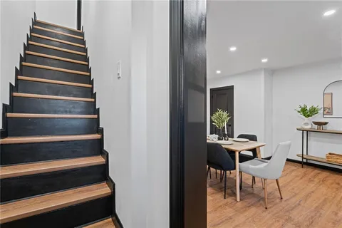 a view of entryway and hall with wooden floor