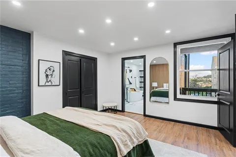 a bedroom with a bed and glass door