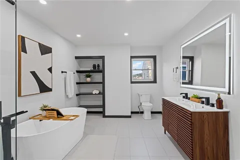 a bedroom with furniture and a bathroom