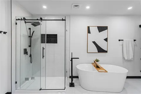 a bathroom with a tub and a shower