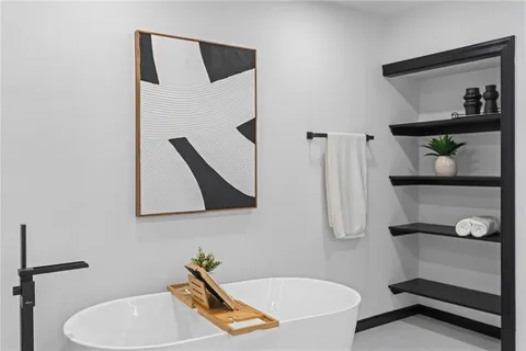 a bathroom with a tub sink and mirror
