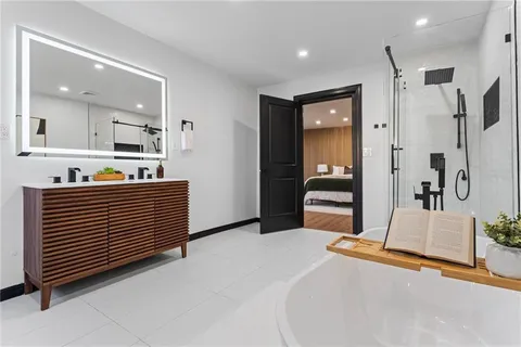 a bedroom with a bed and a large mirror