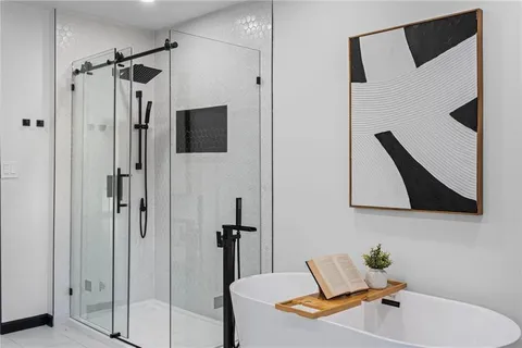 a bathroom with a tub sink and mirror