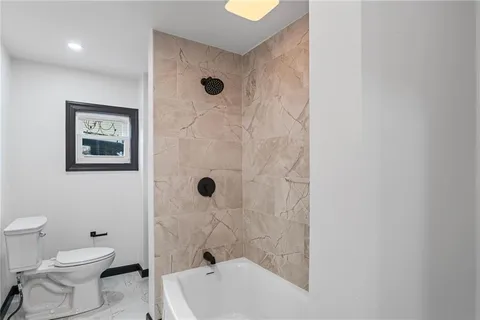 a bathroom with a toilet and a shower