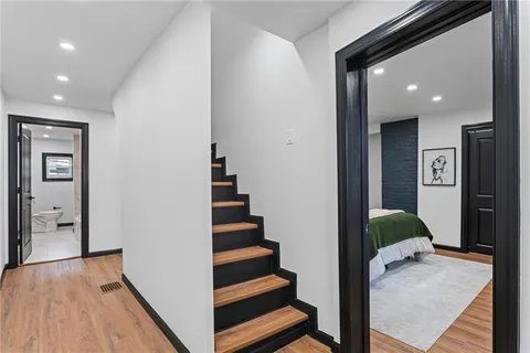 a view of entryway with wooden floor and stairs