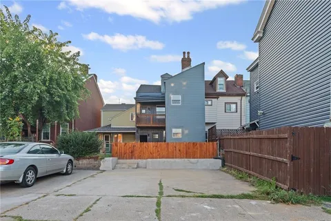 a view of a car park in front of house