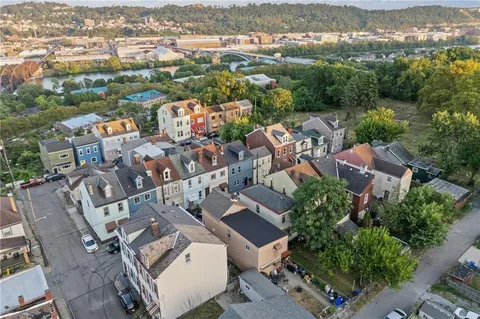 an aerial view of residential house with green space