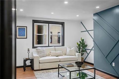 a living room with furniture and a potted plant