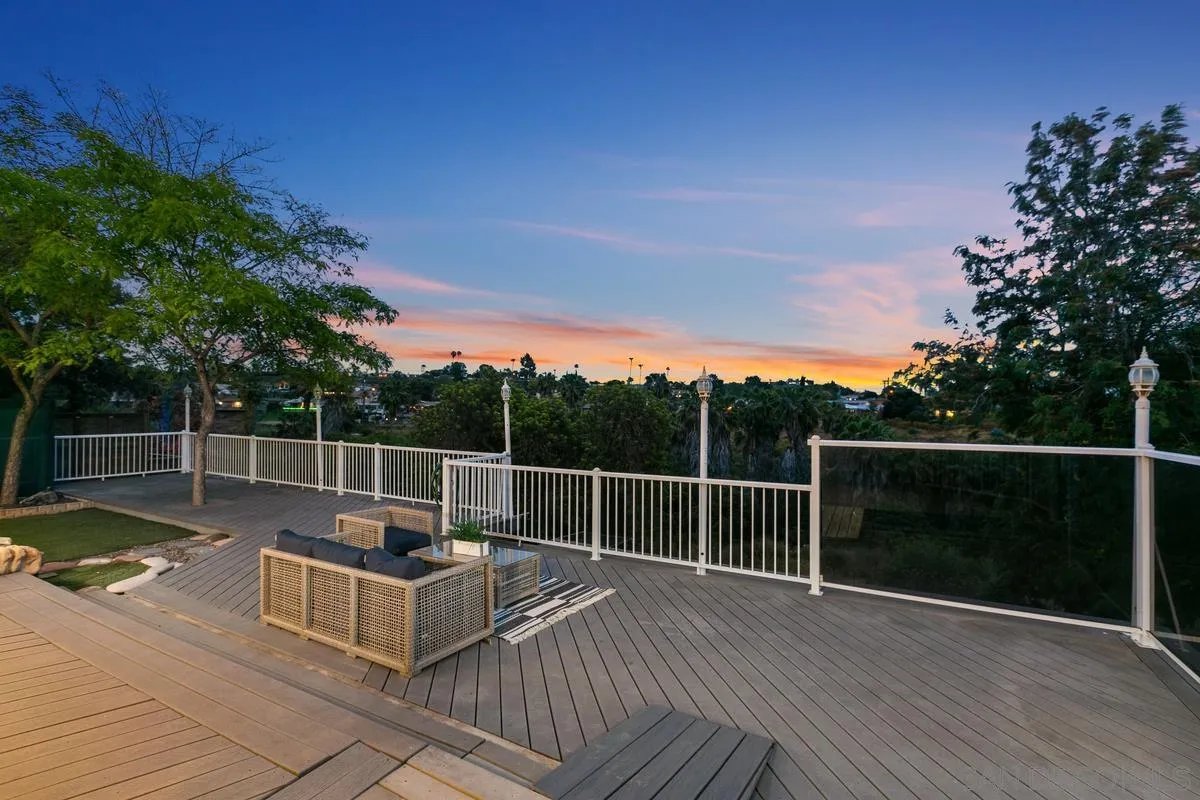 a view of a roof deck with couches and wooden floor