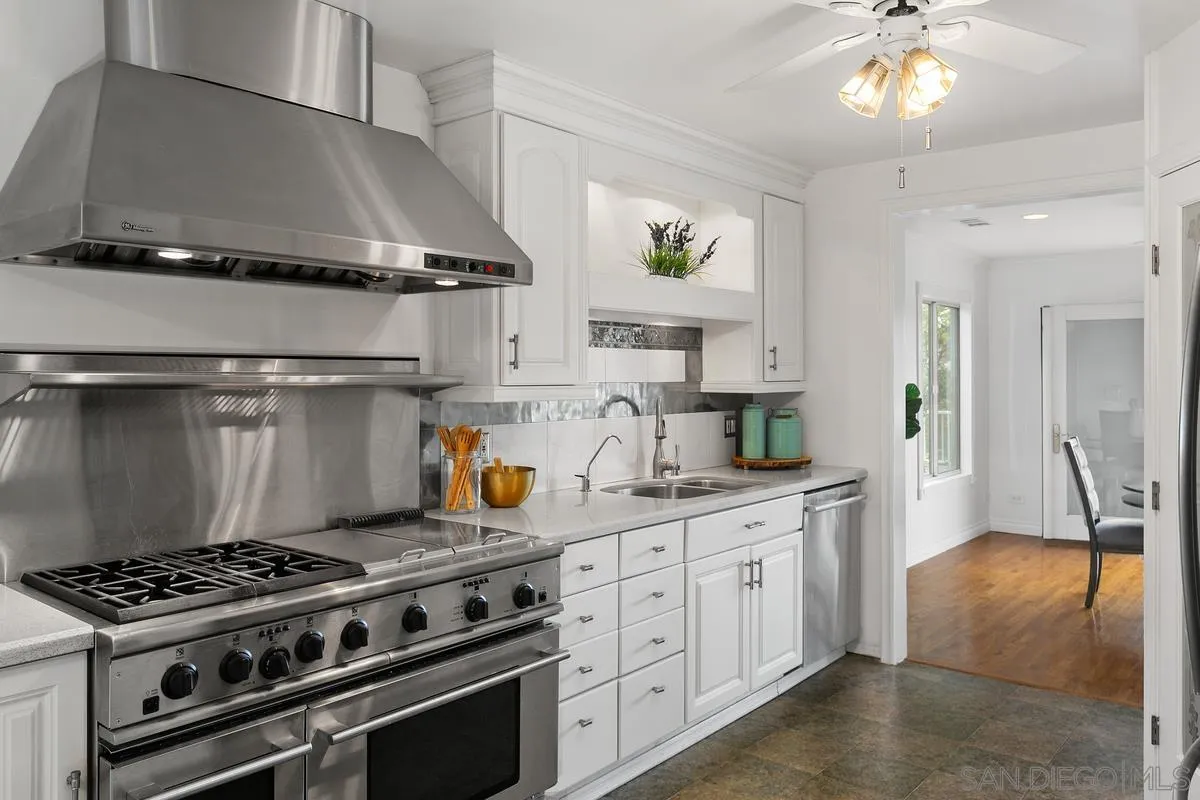 7609 El Paso Street La Mesa, CA 91942 - Photo 17 of 46 a kitchen with stainless steel appliances a stove a sink and cabinets