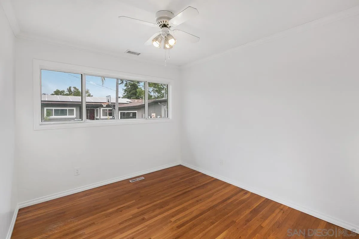 7609 El Paso Street La Mesa, CA 91942 - Photo 20 of 46 a view of a room with wooden floor and ceiling fan