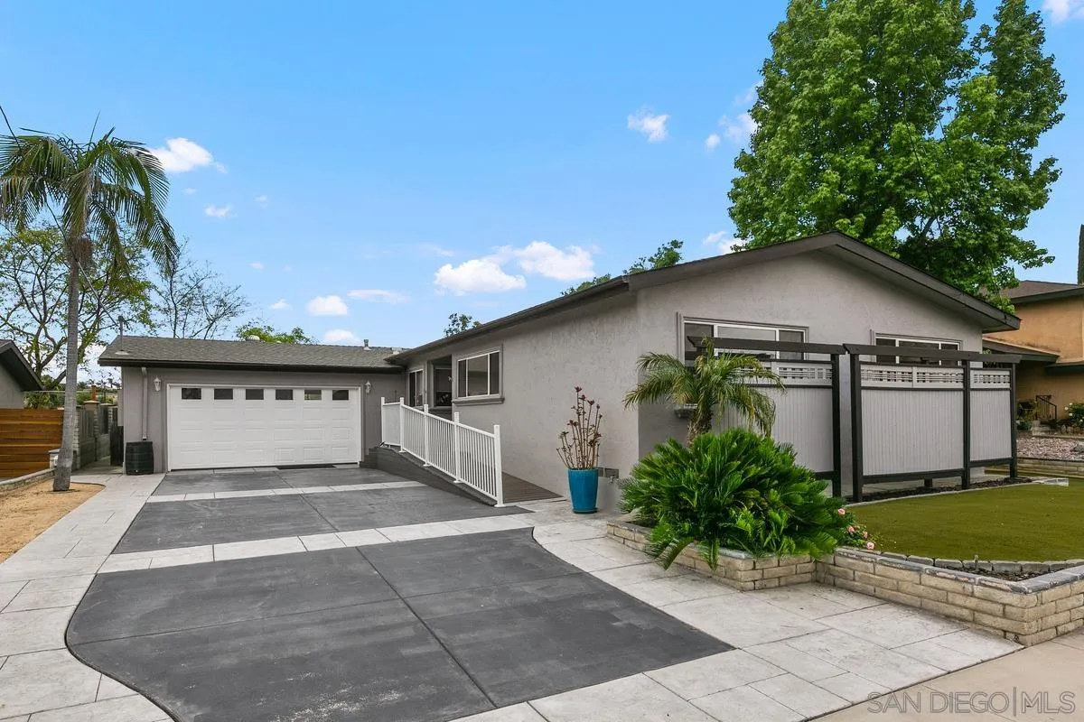 7609 El Paso Street La Mesa, CA 91942 - Photo 5 of 46 a front view of a house with a yard and garage