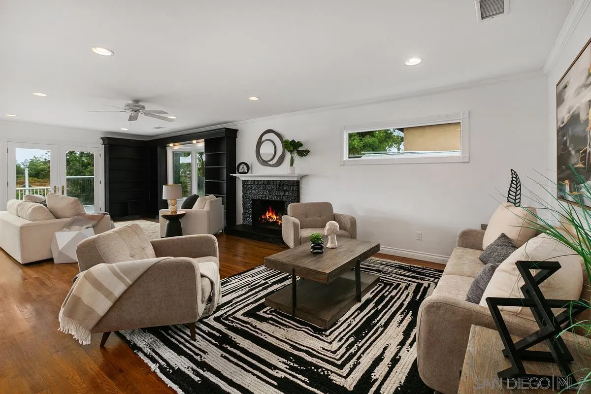 7609 El Paso Street La Mesa, CA 91942 - Photo 8 of 46 a living room with furniture and a fireplace