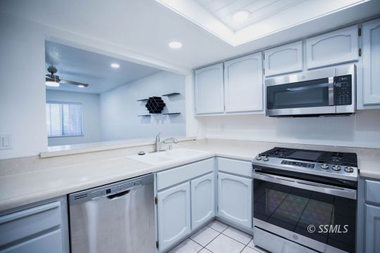 207 East Upjohn Avenue Ridgecrest, CA 93555 - Photo 8 of 20 a kitchen with a sink stove and microwave