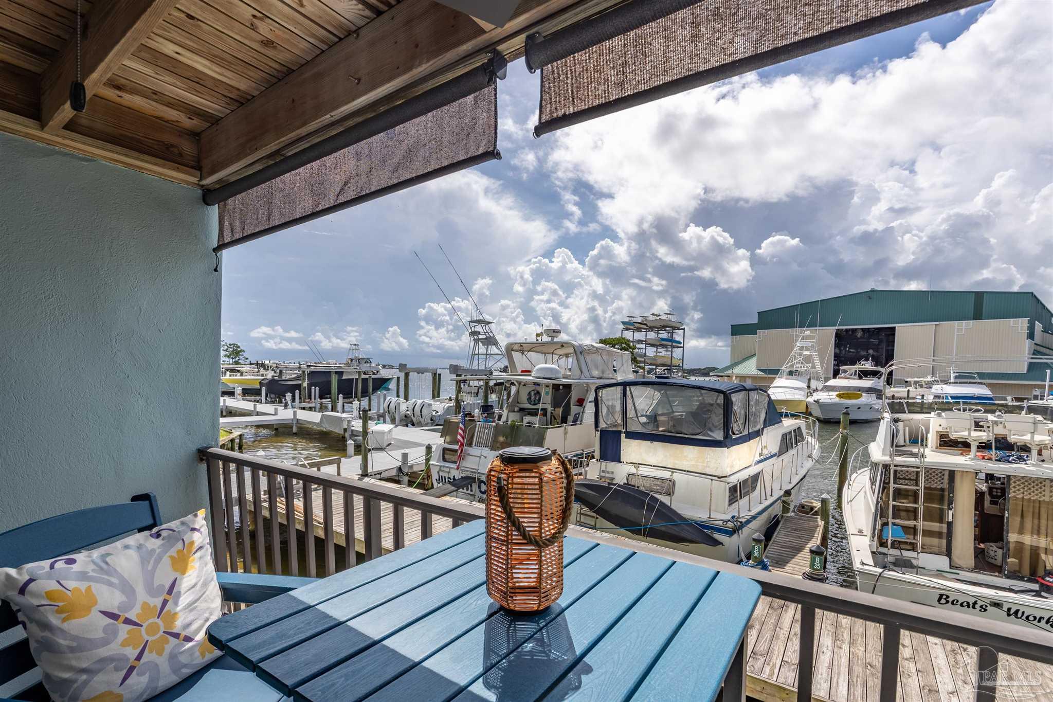 14100 River Road, Unit 122B Perdido Key, FL 32507 - Photo 20 of 46 a view of a balcony with two couches and wooden floor