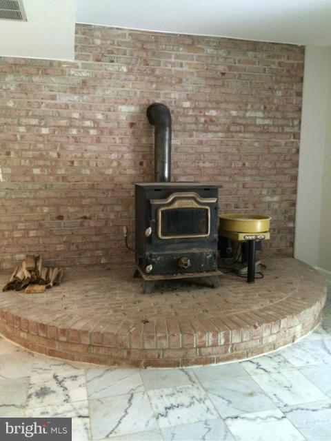 17610 Backbone Road Parkton, MD 21120 - Photo 24 of 30 Wood burning stove in Rec Rm; walk-out to gardens