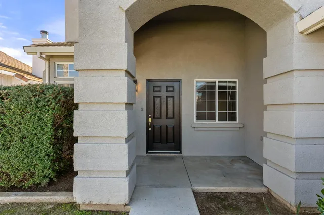 a backyard of a house with table and chairs