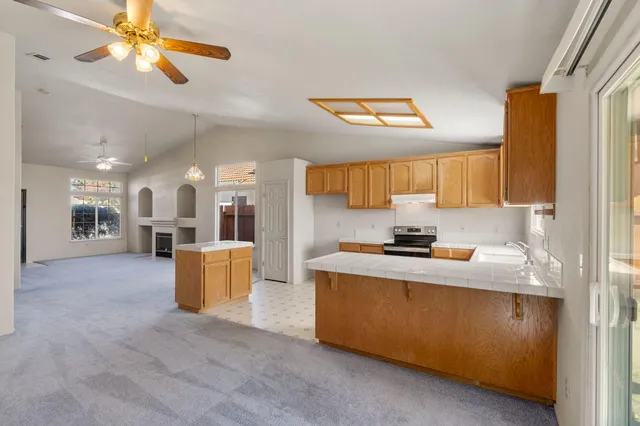 a kitchen with stainless steel appliances granite countertop a sink and cabinets