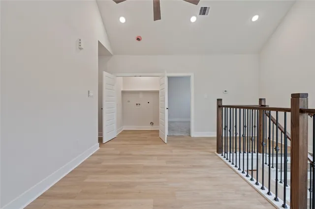a view of a hallway with wooden floor