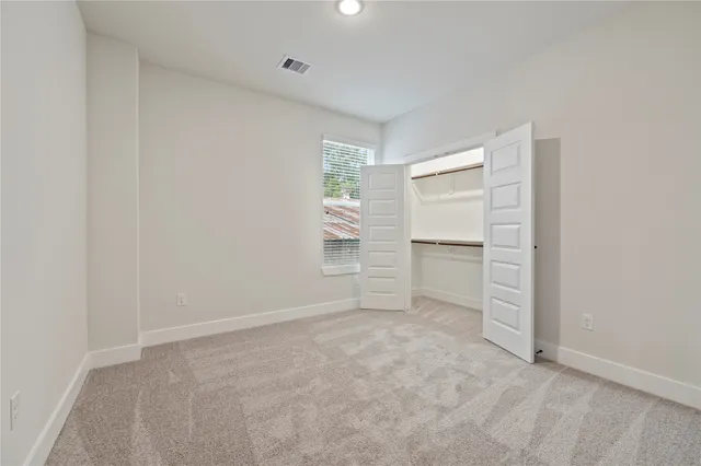 a view of an empty room with a closet