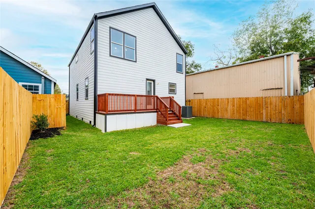a view of backyard with tub and trees