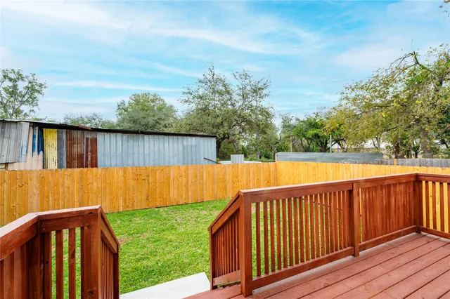 a view of wooden deck and a backyard