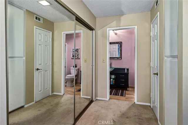 a bathroom with a toilet a sink and mirror