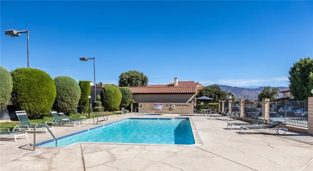 a view of swimming pool with a chairs