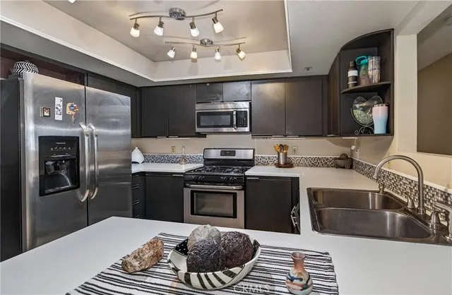 a kitchen with a sink stove and refrigerator