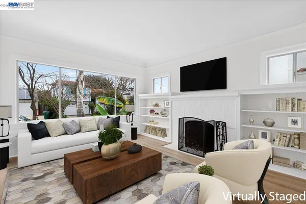 a living room with furniture a fireplace and a flat screen tv