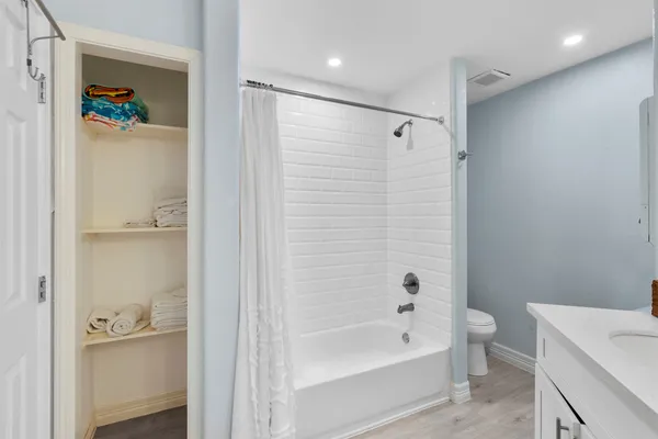 a bathroom with a bathtub a toilet and a shower