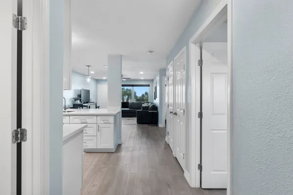 a kitchen with white cabinets and stainless steel appliances