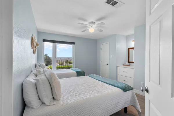 a bedroom with a large bed and a chandelier