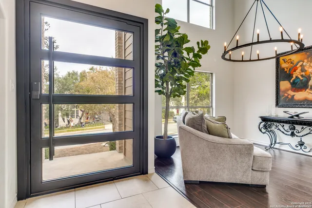 a living room with furniture a window and a potted plant