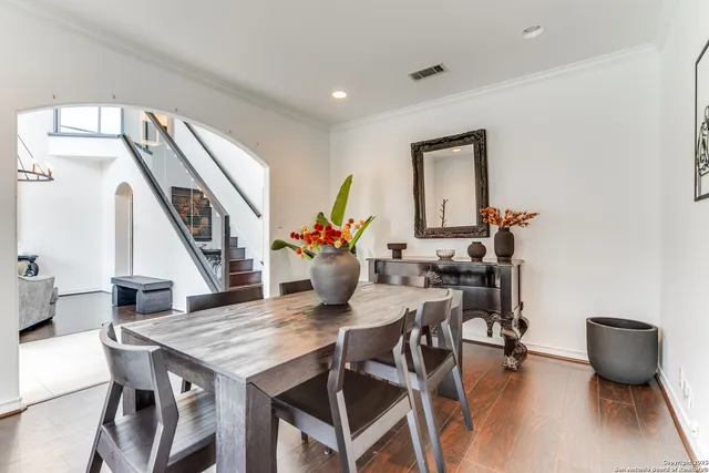a dining room with furniture and floor to ceiling windows