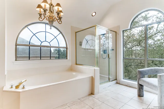 a spacious bedroom with a bed and a flat screen tv