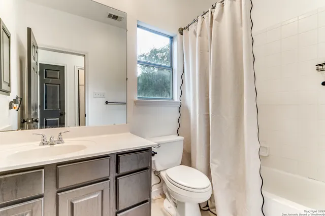 a bedroom with a bed and a table