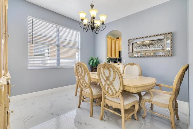 a view of a dining room with furniture and a chandelier