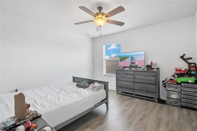 a bedroom with a bed and a chandelier
